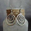 Geometric spiral earrings with distressed silver finish measuring 2.6cm wide by 5cm long