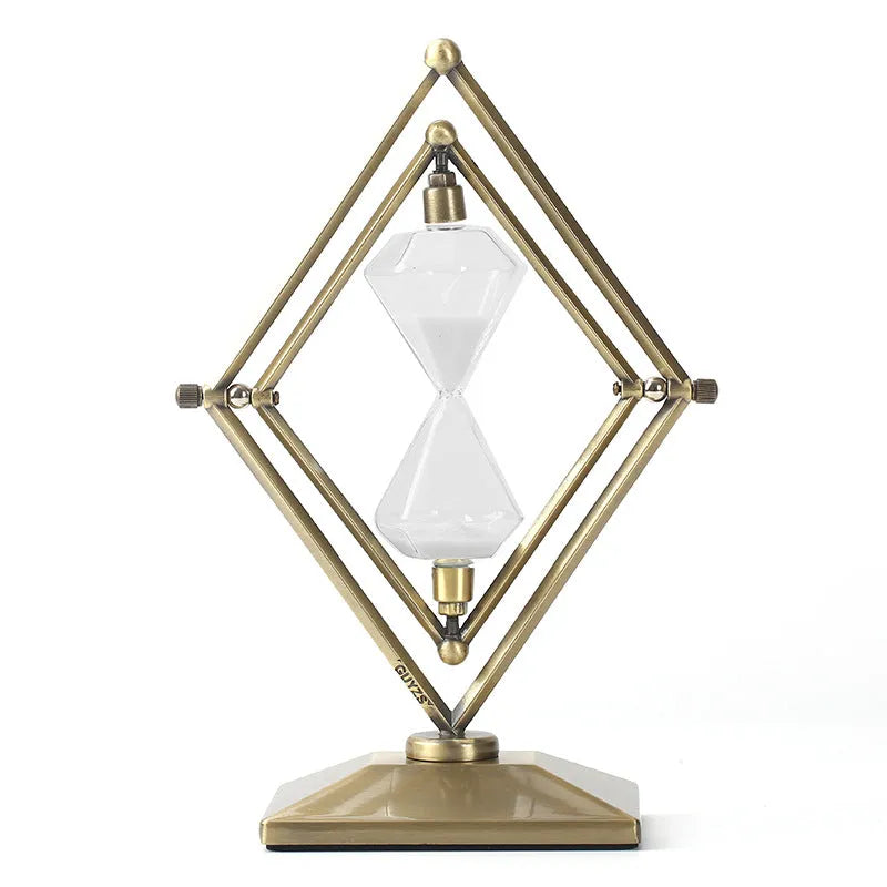 Glass sand clock timer with detailed metal ornaments in a bronze finish, showing modern simplicity style.