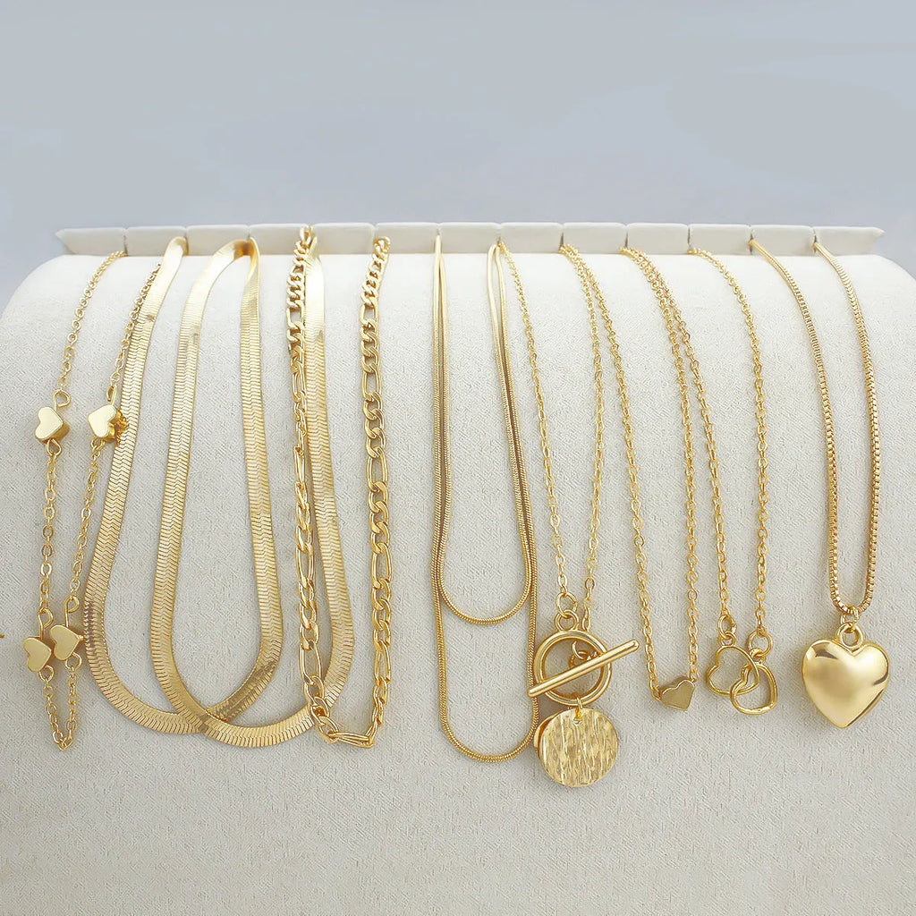 Women's gold necklace set with 10 pendant pieces on adjustable snake bone chain
