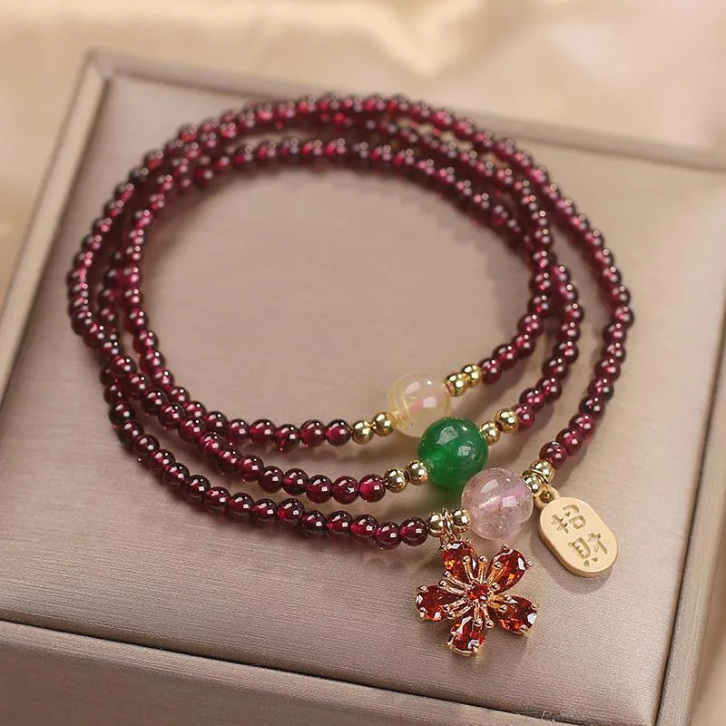 Women's crystal pomegranate bracelet with red cherry blossom beads and sequin detailing