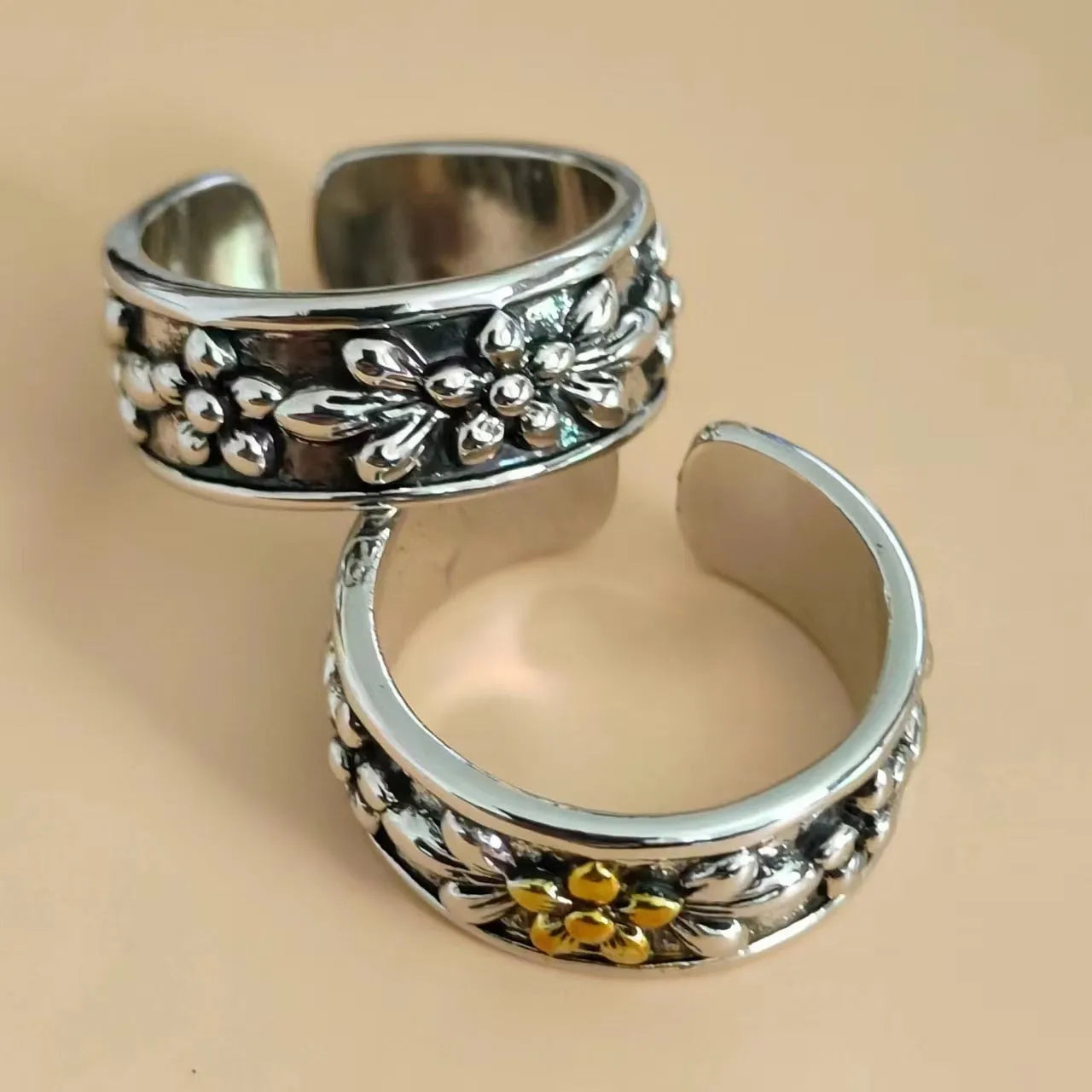 Vintage antique silver gold flower open ring with adjustable band and floral camellia motif on light background