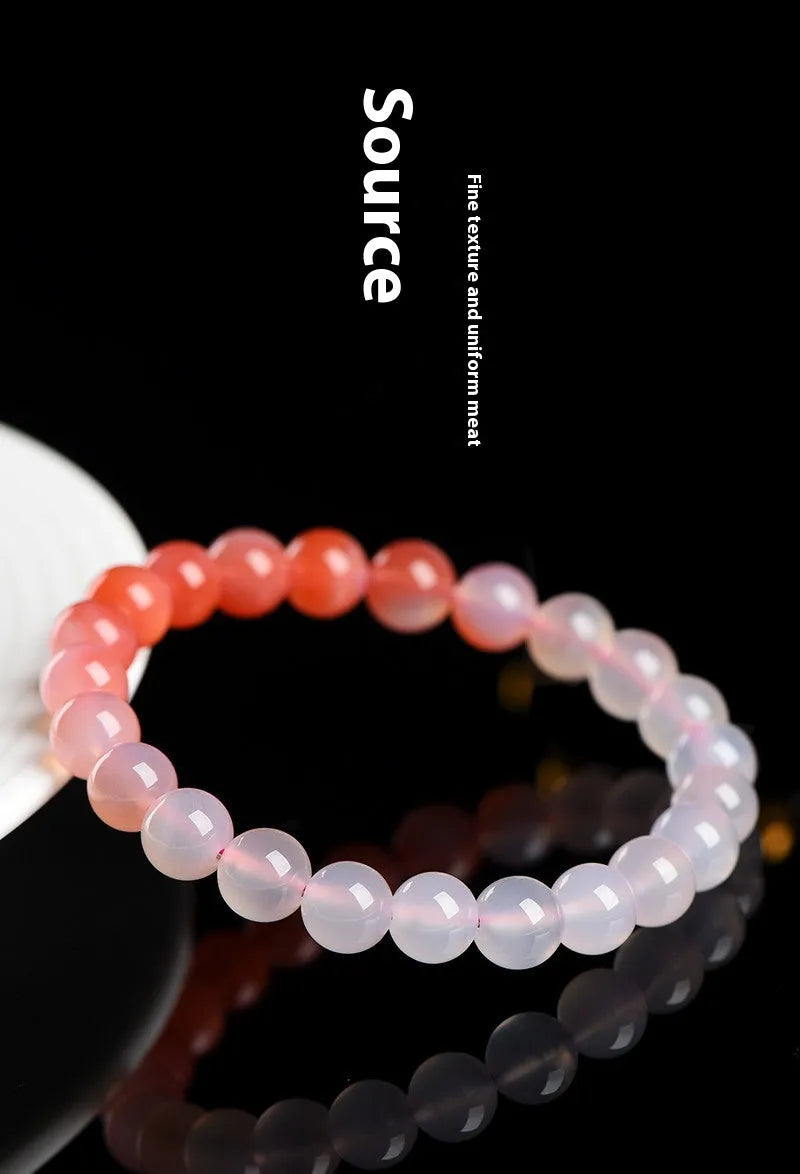 Natural gradient Yanyuan agate bracelet with geometric beads on a wrist, showing colour transition.