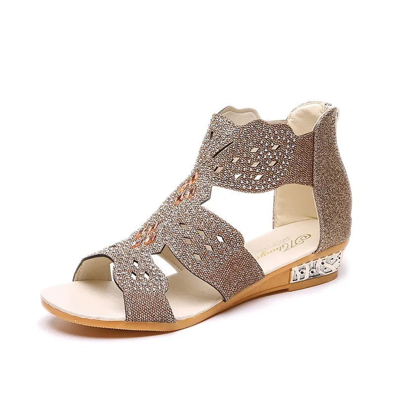 Women's flat open-toe sandals with rhinestone detail and a back zipper in beige, black, and gold.