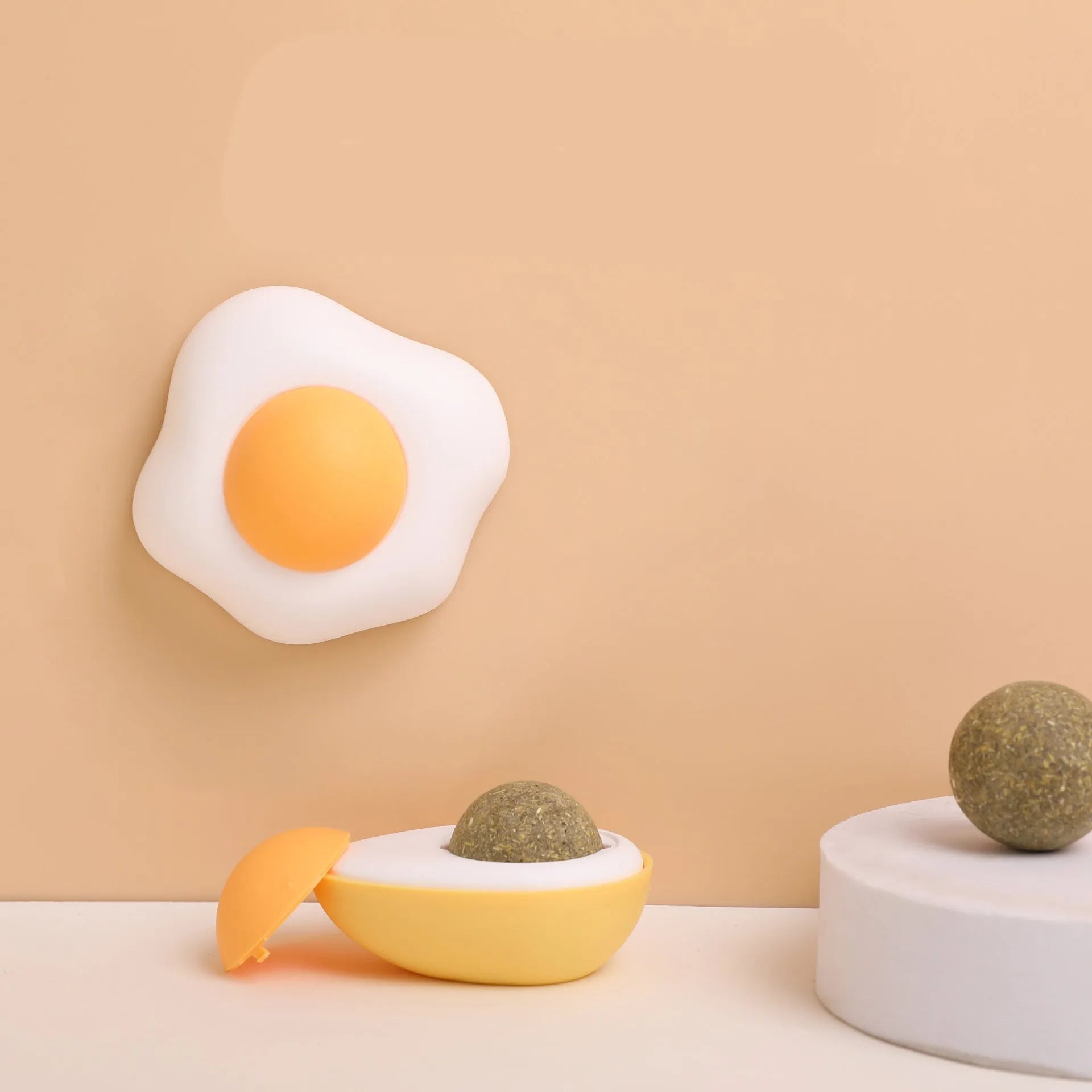 Soft plush catnip ball toy in fried egg and poached egg shapes for wall-mounted cat play
