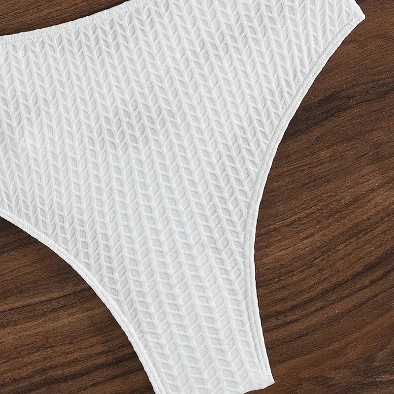 White backless women's bikini swimsuit on a mannequin
