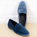 Blue women's loafers with black rubber sole and round toe in low-top slip-on design