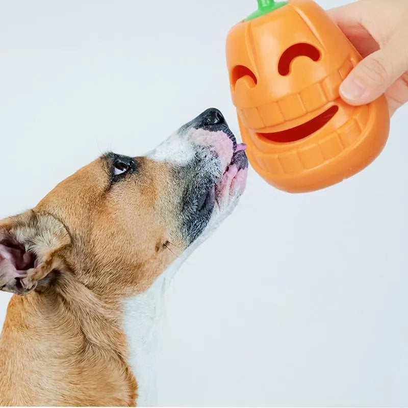 Yellow pumpkin-shaped TPR dog chew toy for aggressive chewers on white background