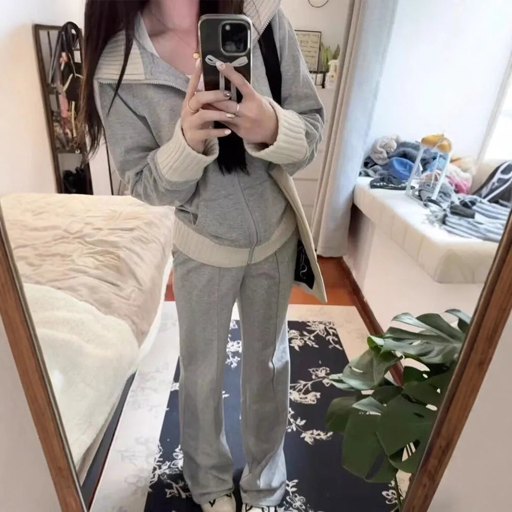 Light gray women's coat and wide leg trousers two-piece set with pockets on a plain background