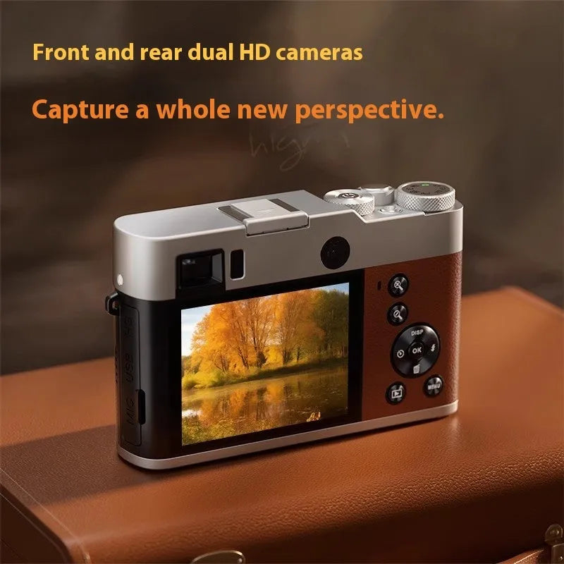 Black or brown 5K HD digital camera with dual lenses and an optical viewfinder on a table.