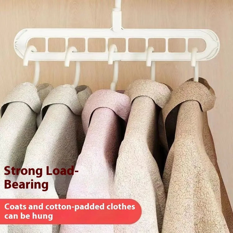 Green plastic nine-hole multifunctional clothes hanger for trousers on a white background.