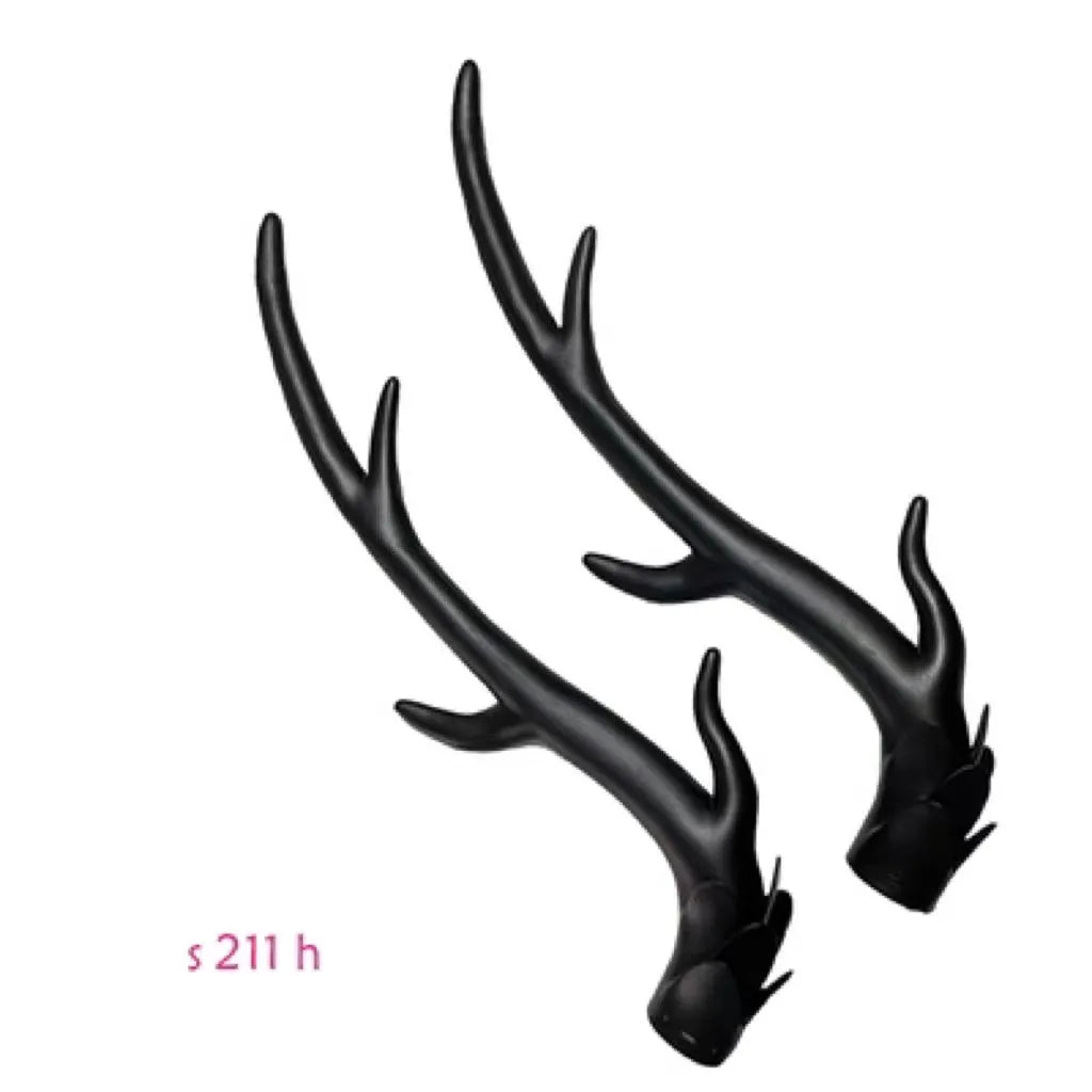 A pair of resin dragon horn decorations for motorcycle helmets in black, shown next to a ruler for scale.