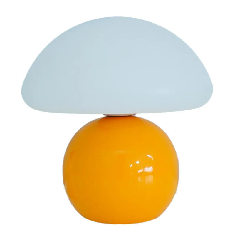 Cream ceramic mushroom table lamp with USB power cord on a bedside table, available in yellow