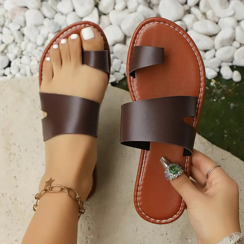 Women's beige round toe flat bottom slippers with PU upper on a light background