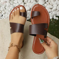 Women's beige round toe flat bottom slippers with PU upper on a light background