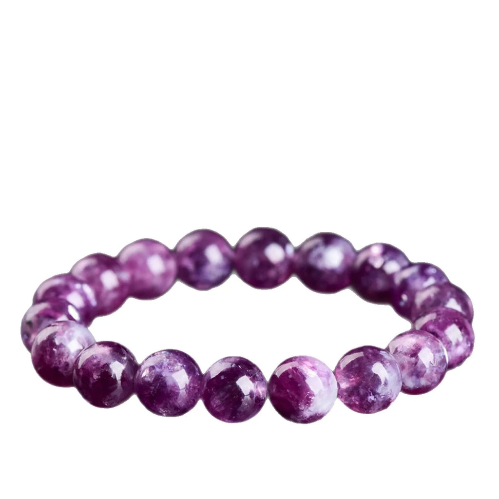Polished geometric crystal bracelet in purple and pink hues on wrist.