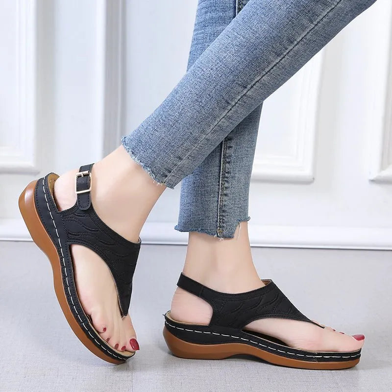 Women's solid colour wedge heel flip flop sandals with an adjustable buckle strap.