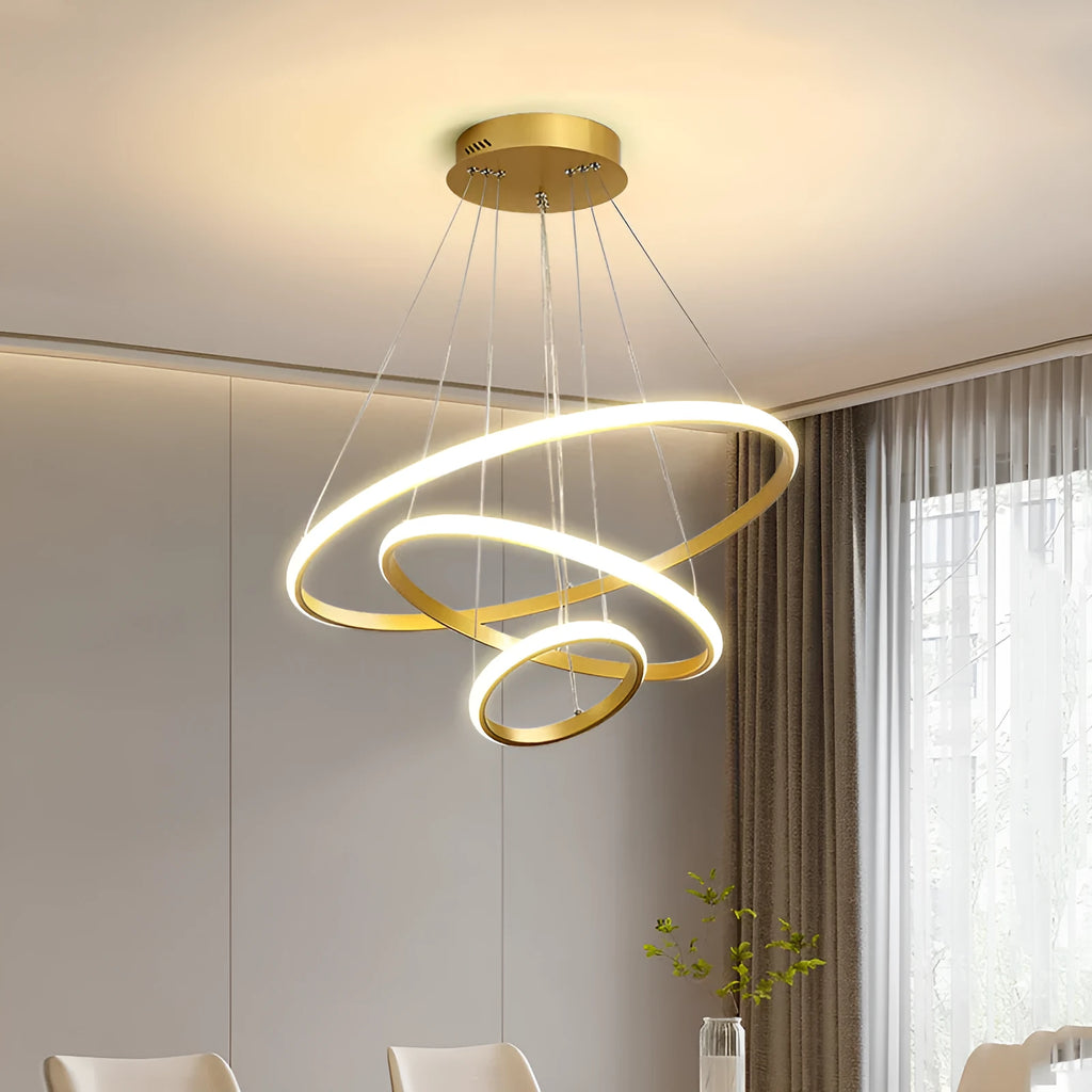 Gold smart LED chandelier with aluminium alloy build and tiered shades over a dining table
