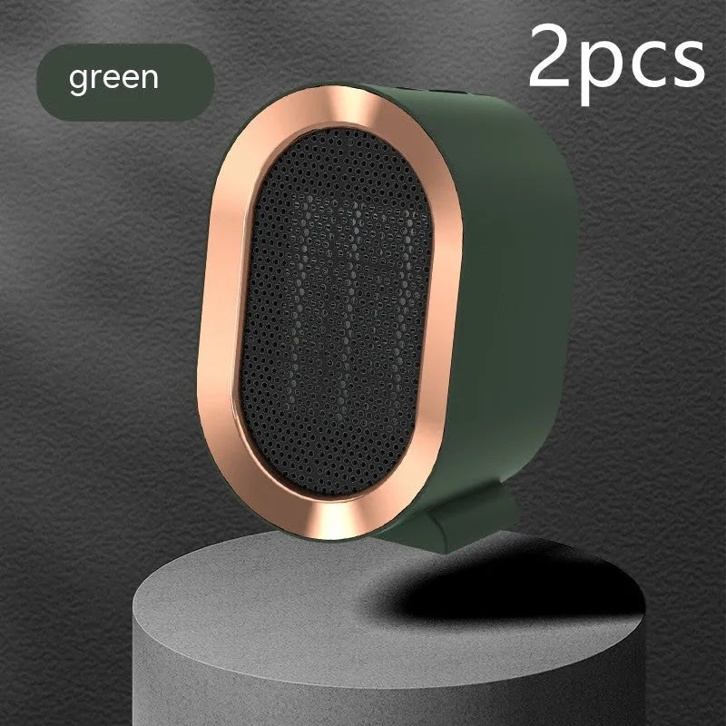 Desktop electric fan heater with black casing and UK plug, showing control knob and air vents