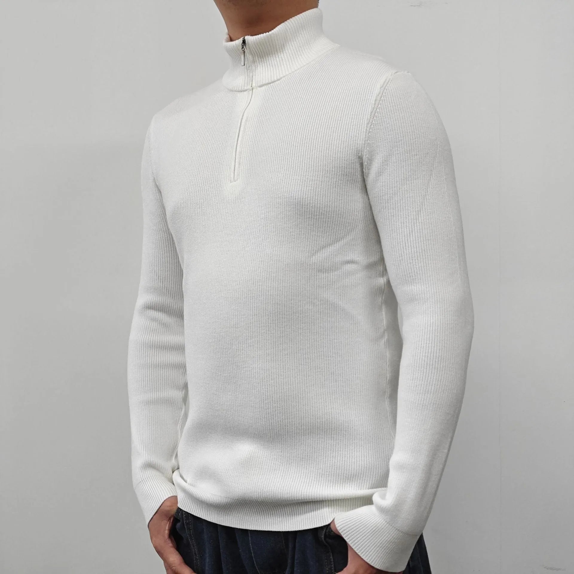 Man wearing a grey half turtleneck zip front sweater, a casual cotton blend pullover.