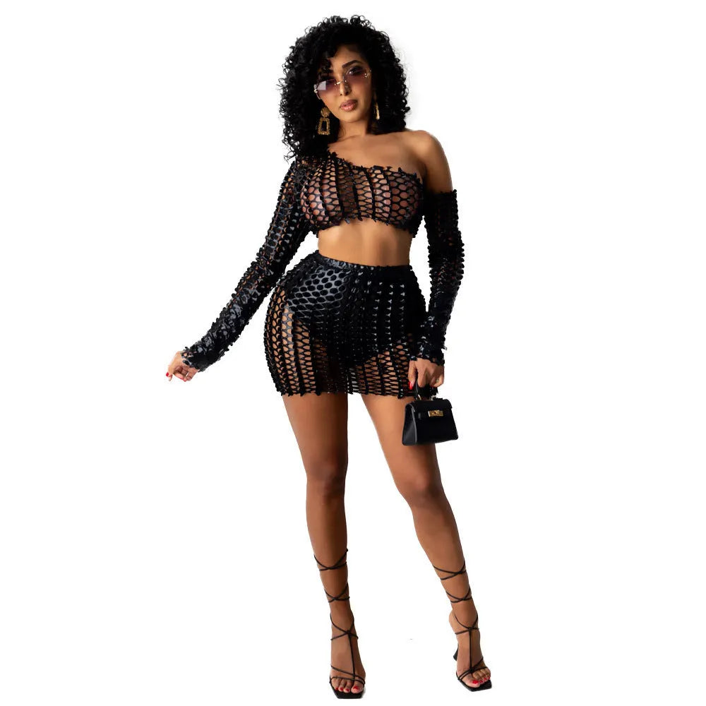 Women's black hollow-out net sleeveless top and short skirt two-piece dress set on a hanger.