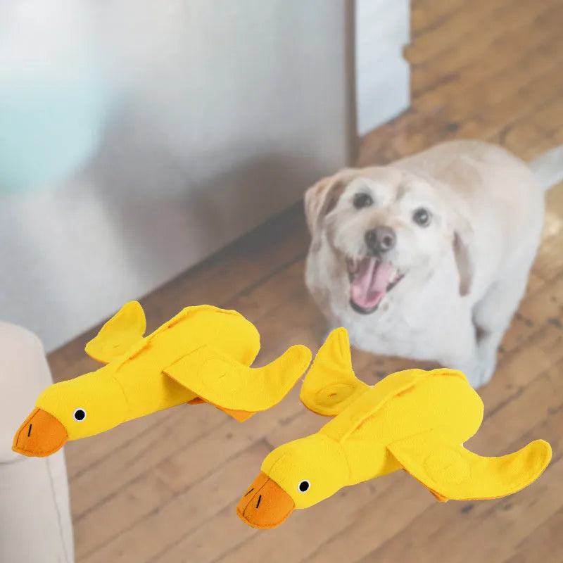 Yellow teddy dog training toy with integrated duck doll and food leak design for scent work
