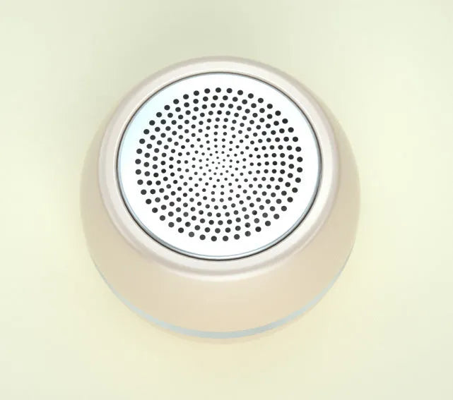 A5 portable mini speaker in red with 3.5mm audio plug and ABS plastic casing on a table
