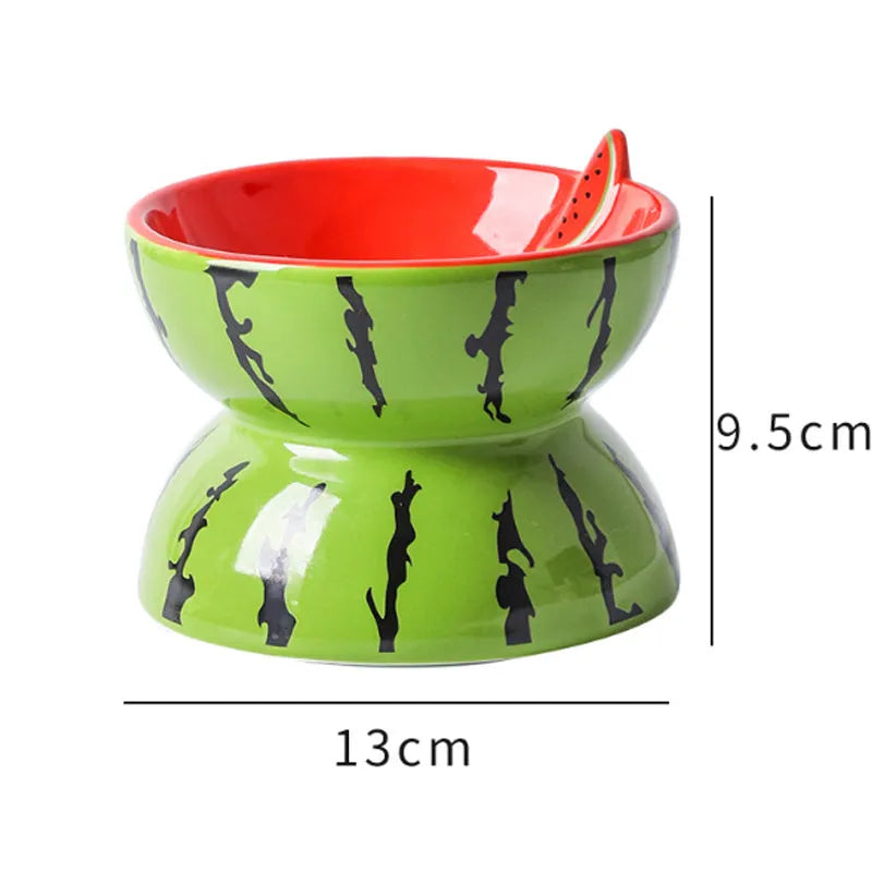 Ceramic elevated cat bowl with tilted orange fruit pattern and non-slip base.