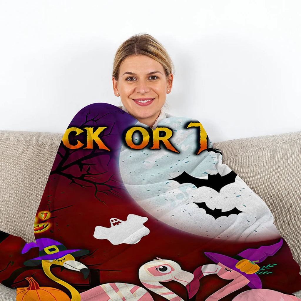 Purple flannel Halloween flamingo printed blanket on a sofa, size 130x150cm