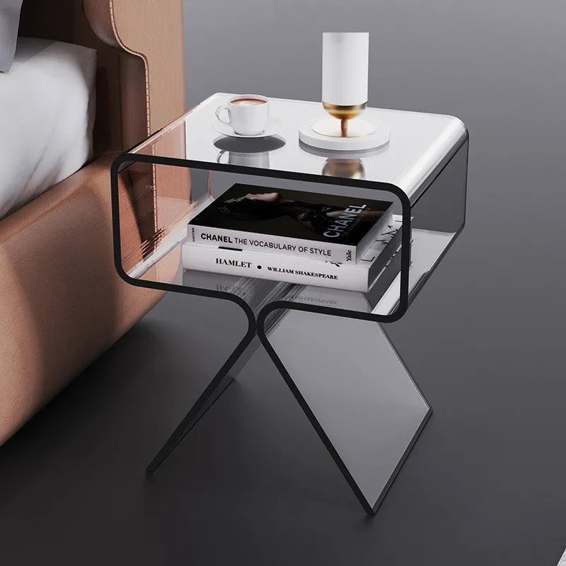 Minimalist acrylic side table in transparent black, 39x30x45cm, beside a sofa in a living room