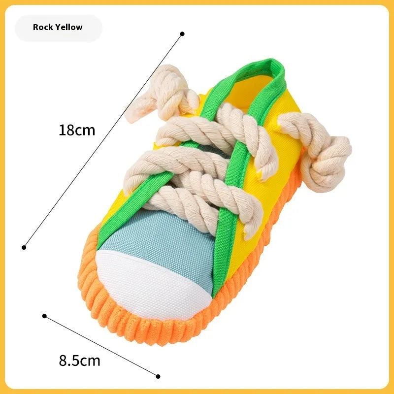 Plastic dog toy shaped like slippers in yellow, black, or blue, designed for chewing and making sound.