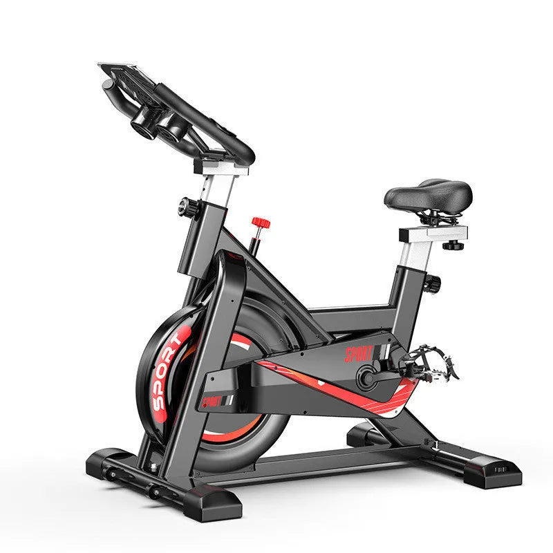 Black upright spinning bike with console and infinite resistance knob on a home gym floor