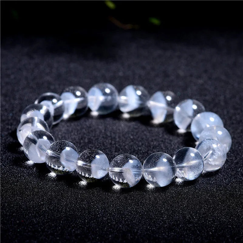 Women's white crystal ghost pyramid bracelet with Ruyi charm on a wrist, showing adjustable sizing.