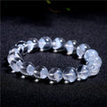 Women's white crystal ghost pyramid bracelet with Ruyi charm on a wrist, showing adjustable sizing.