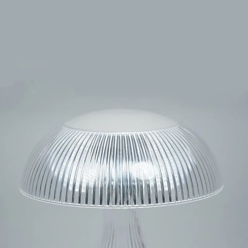 Small white rechargeable table lamp with USB cable and three colour light settings.