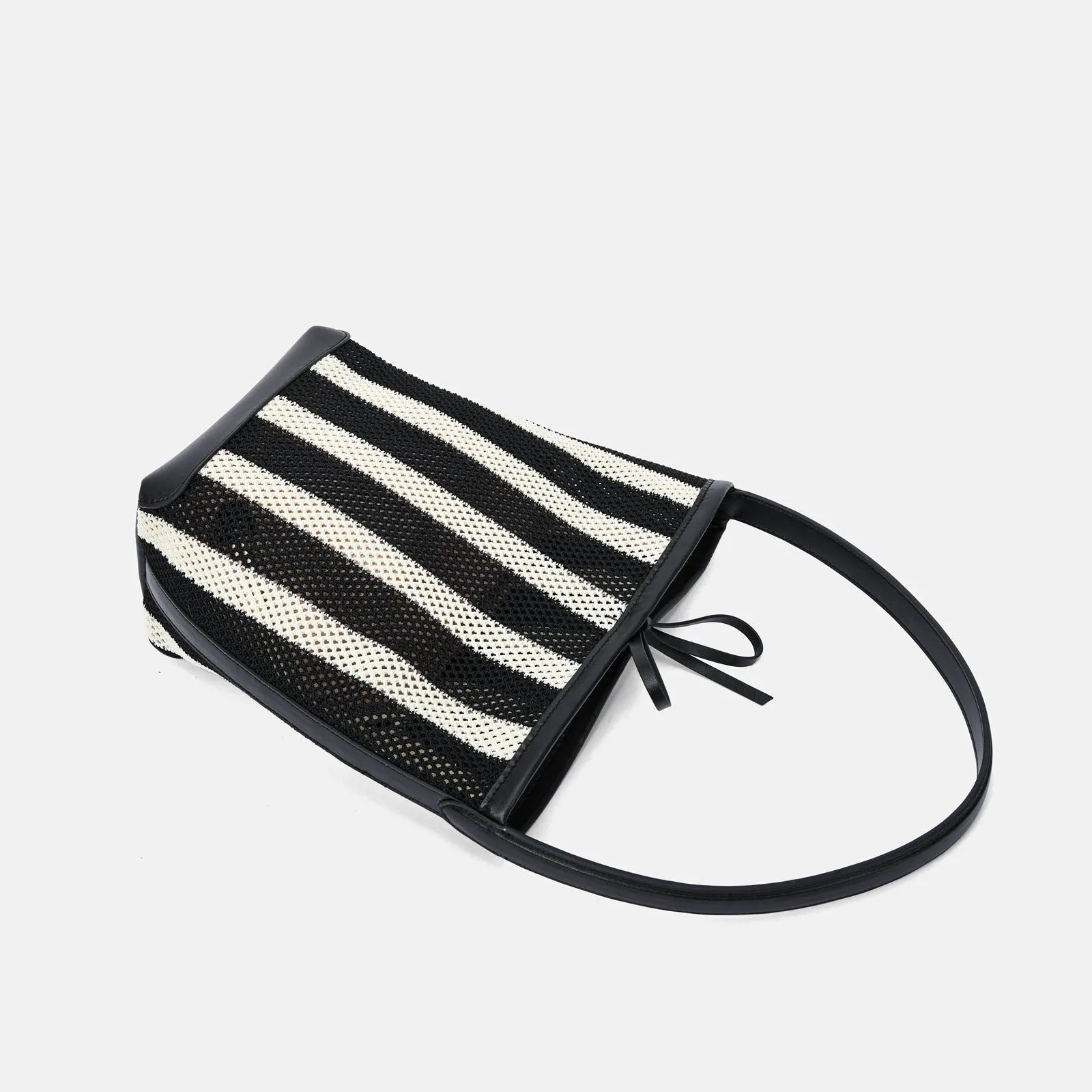 Black and white striped woven shoulder bag with bucket shape showing dimensions