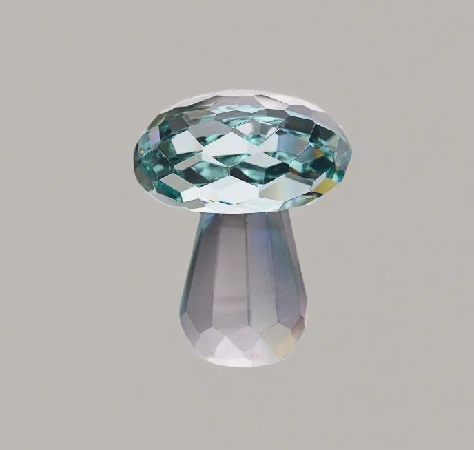 Colourful transparent crystal mushroom decoration on a white background.