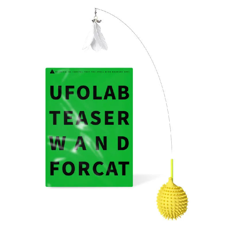 Green plastic cat corner scratcher with a cat teaser stick placed on a wooden floor