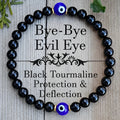 Men's black 8mm devil's eye obsidian beaded bracelet with geometric pattern on table