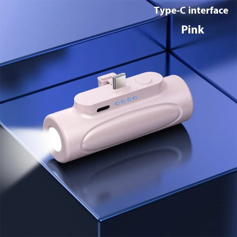 Black and pink portable power bank with integrated LED flashlight, showing USB-C and Apple port options.