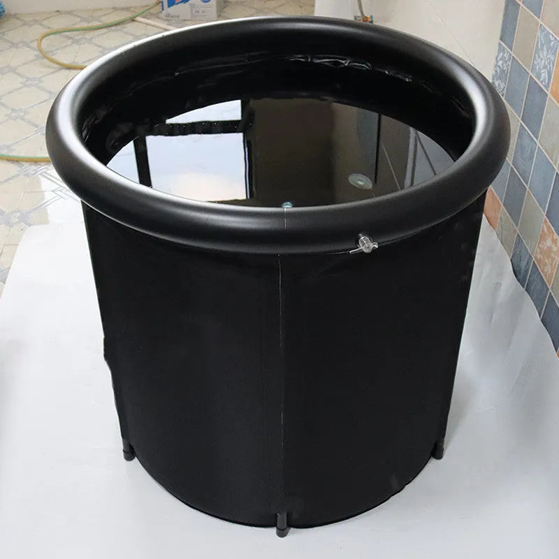 Black inflatable portable ice bath tub with weather lid, shown outdoors.