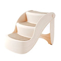 Foldable plastic step ladder for small pets on a home floor next to a sofa.