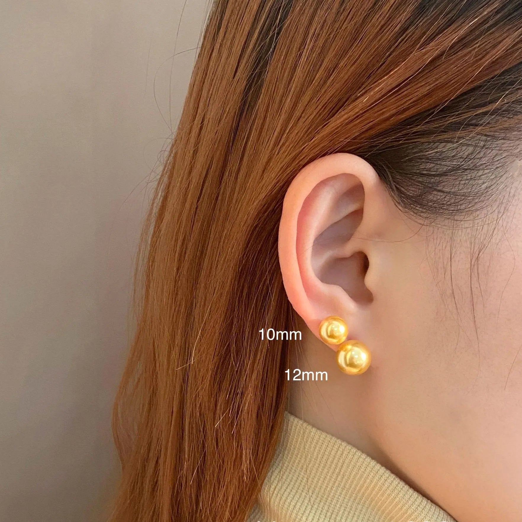 A pair of large pearl stud earrings with a geometric silver setting and an eight-point star detail.