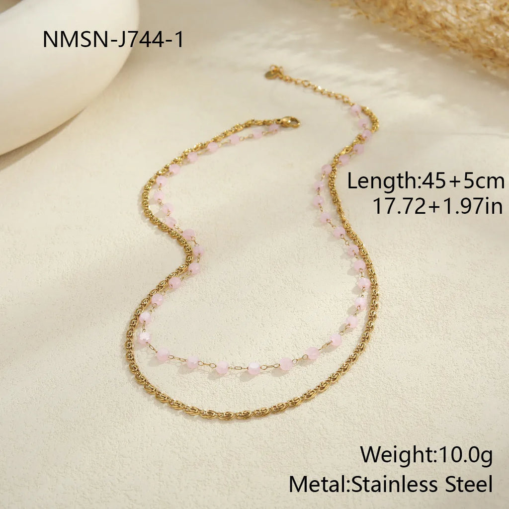 Gold-plated double-layer stainless steel necklace with colourful beads and geometric pendant on woman