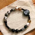 Hand-woven natural black agate and ceramic bracelet with geometric round bead design
