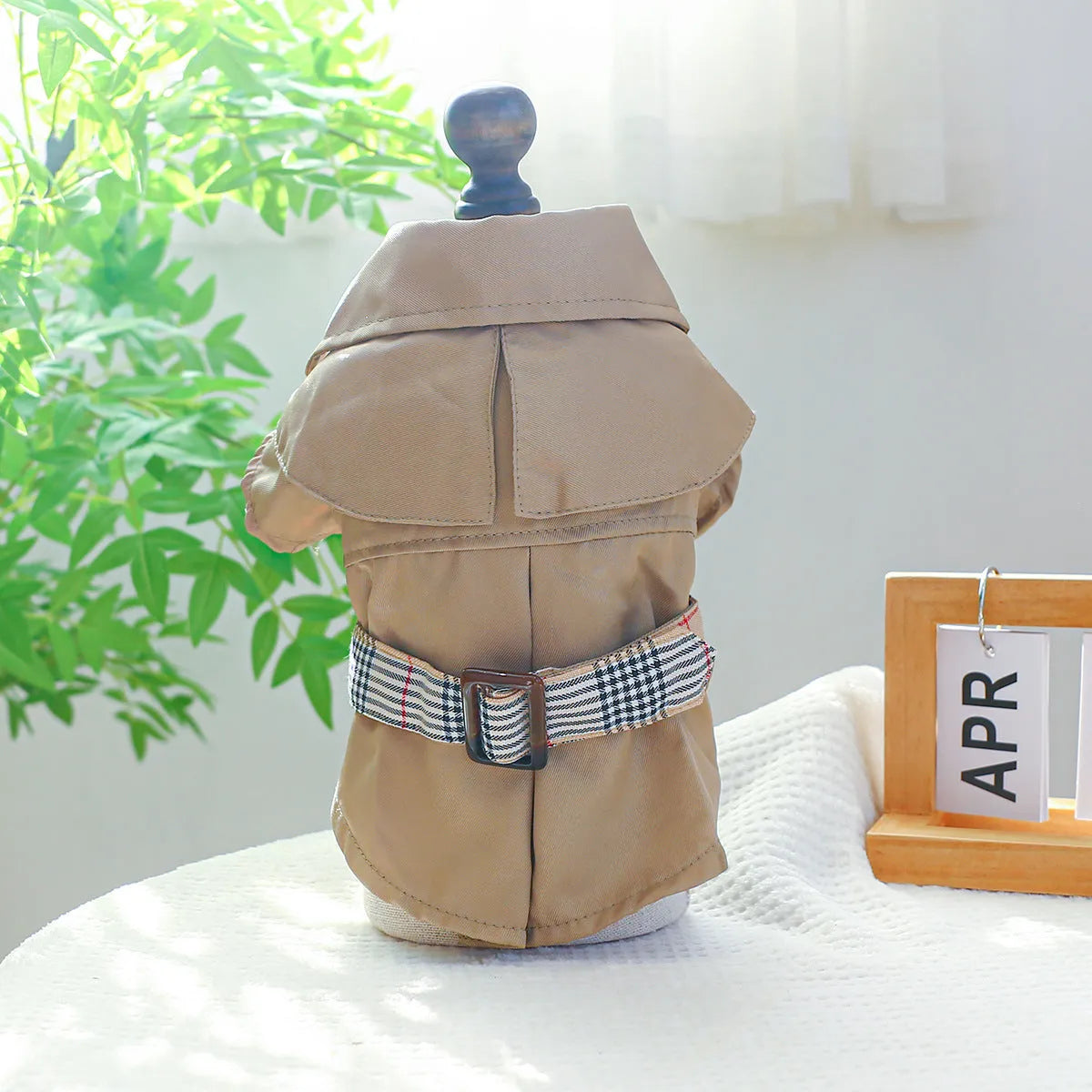Khaki polyester trench coat for dogs on a neutral background showcasing front view and button closure