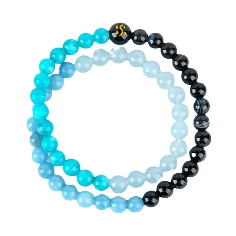 Handmade women's crystal double ring bracelet in five elements colours on a wrist.