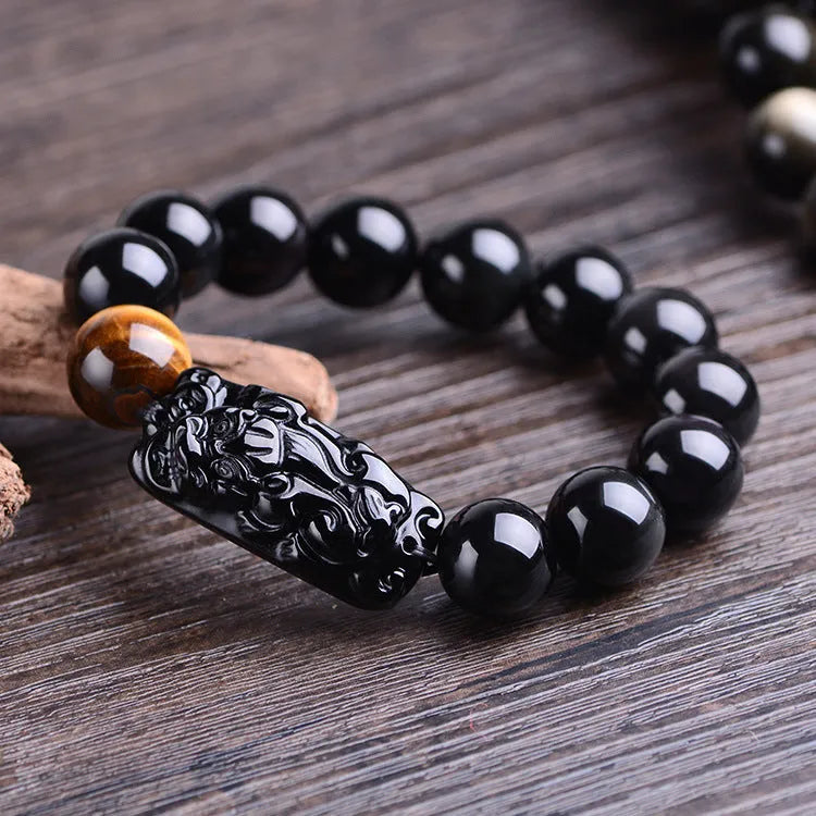 Natural obsidian Pi Xiu bracelet with carved charm, 12mm beads, on a gift box