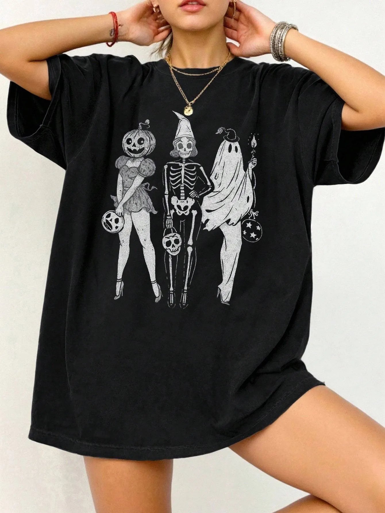 Loose short-sleeve cotton T-shirt on a hanger, showing round neckline, available in black, green, grey, and orange.