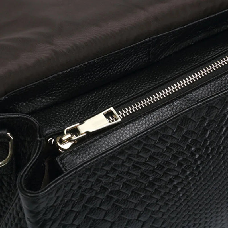 Genuine leather women's woven crossbody bag in black with embossed finish and soft handle