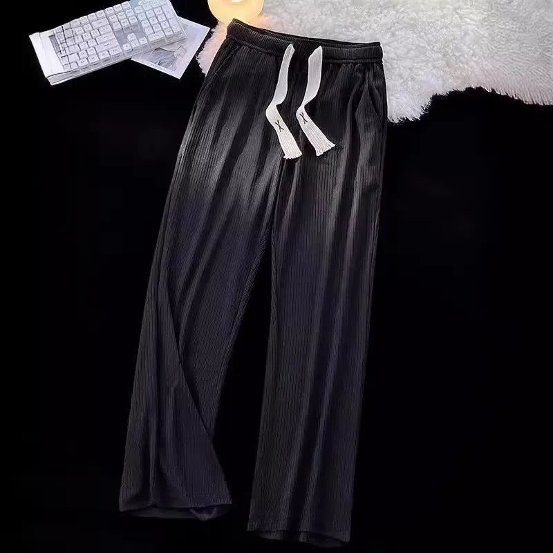 Men's loose straight-leg casual cotton trousers in black, shown flat.